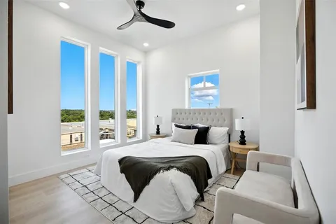 a bedroom with a bed and a large window