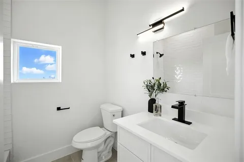 a bathroom with a sink a toilet and a mirror