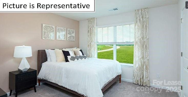 1365 Secrest Cmns Drive Monroe, NC 28112 - Photo 18 of 21 a spacious bedroom with a bed and a window