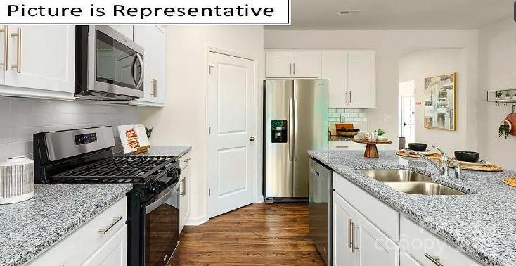 1365 Secrest Cmns Drive Monroe, NC 28112 - Photo 4 of 21 a kitchen with stainless steel appliances granite countertop a sink stove and refrigerator