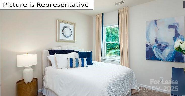 1365 Secrest Cmns Drive Monroe, NC 28112 - Photo 8 of 21 a bedroom with a bed and a window