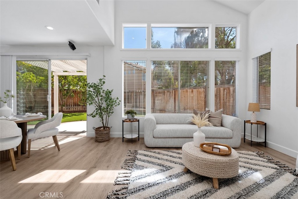 56 Acorn Ridge Rancho Santa Margarita, CA 92688 - Photo 11 of 57 Sitting Area / Dining Area: Expansive windows and a sliding glass door connect this light-filled space to the backyard patio, creating easy indoor-outdoor flow.