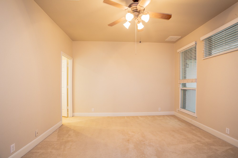 14812 Avery Ranch Boulevard, Unit 28 Austin, TX 78717 - Photo 11 of 21 an empty room with a window and a fan