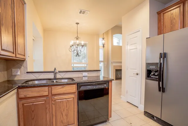 a kitchen with a sink stove and refrigerator