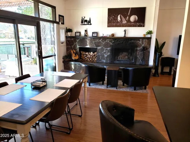 a view of a patio with a dining table and chairs with wooden floor