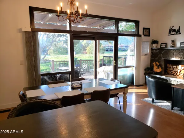 a view of a patio with a dining table and chairs with wooden floor