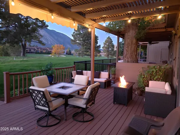 a view of a house with backyard porch and furniture