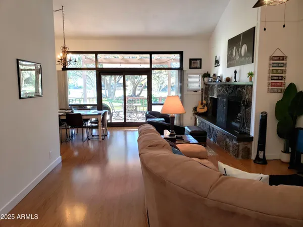 a living room with furniture and a floor to ceiling window