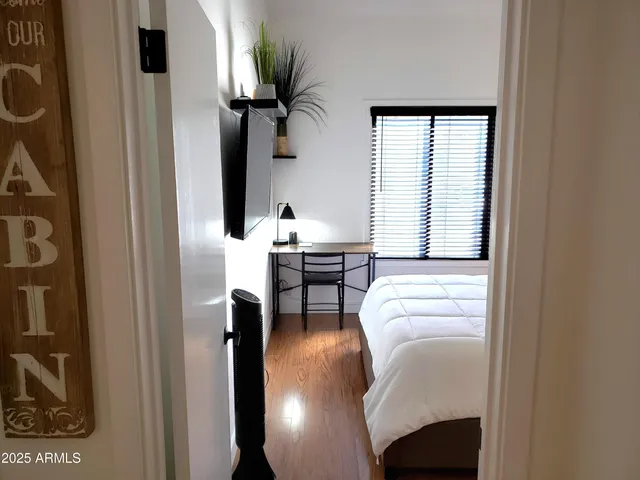 a view of a hallway with wooden floor