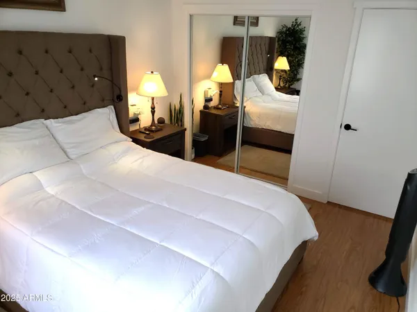 a bedroom with two beds and a flat screen tv