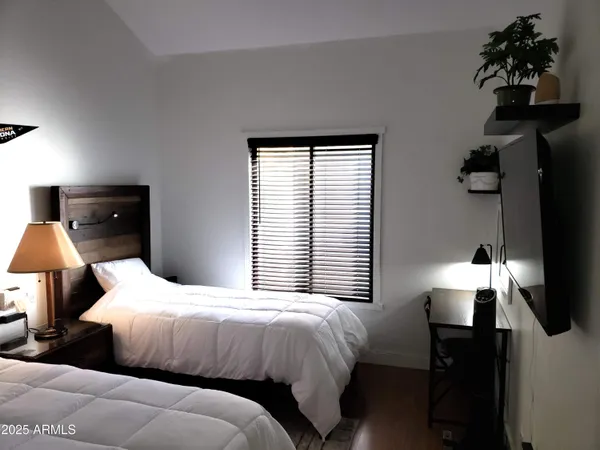 a bedroom with a bed and a window