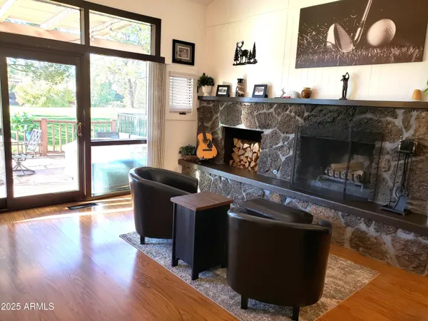 a living room with furniture a large window and a fireplace
