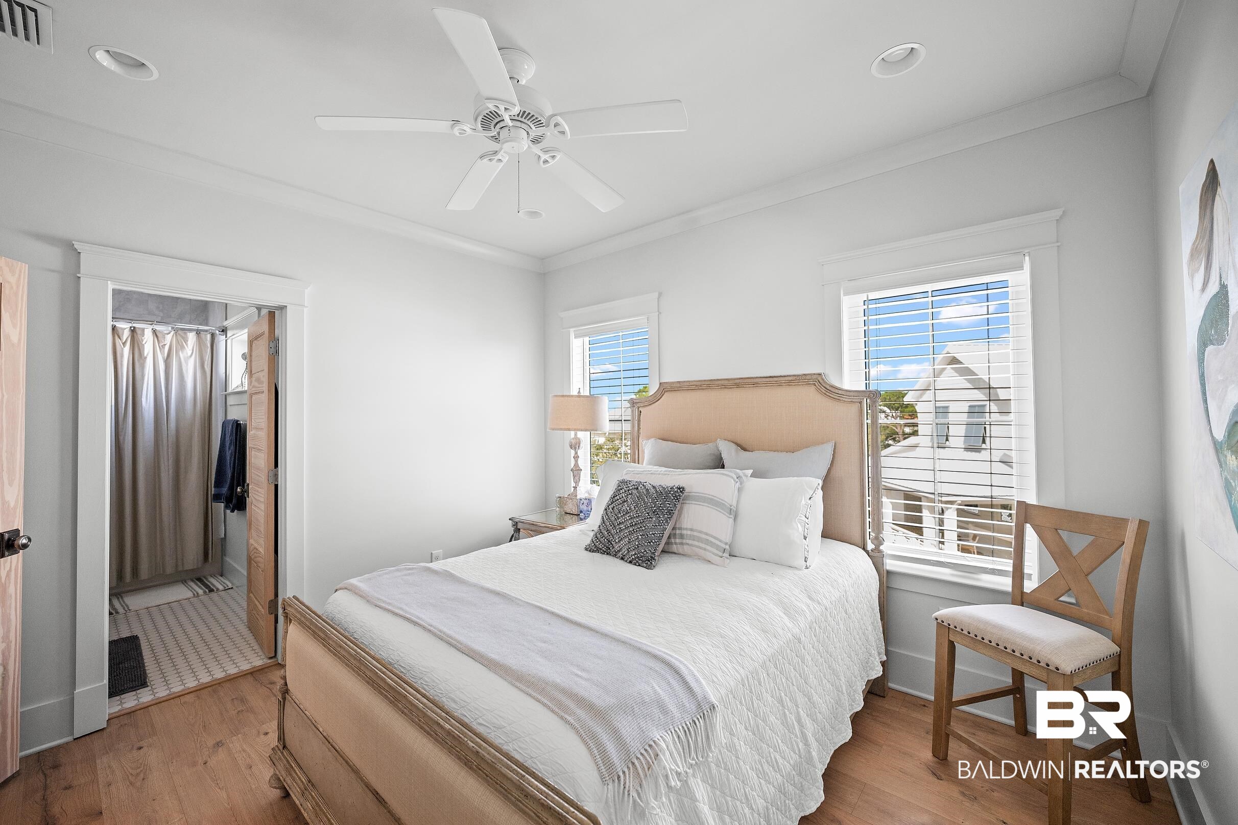 33186 Marlin Key Drive Orange Beach, AL 36561 - Photo 60 of 87 Bedroom featuring wood finished floors, crown molding, a ceiling fan, and connected bathroom