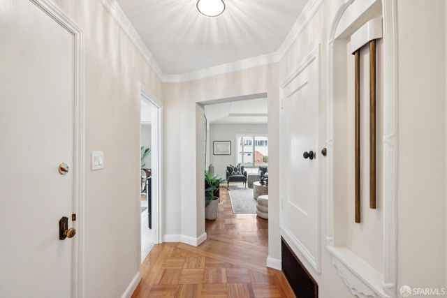 a view of a hallway with bathroom and wooden floor