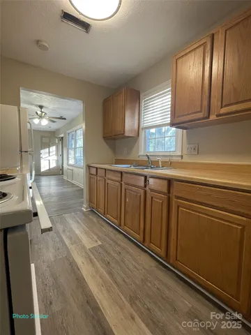 a kitchen with cabinets a sink and appliances