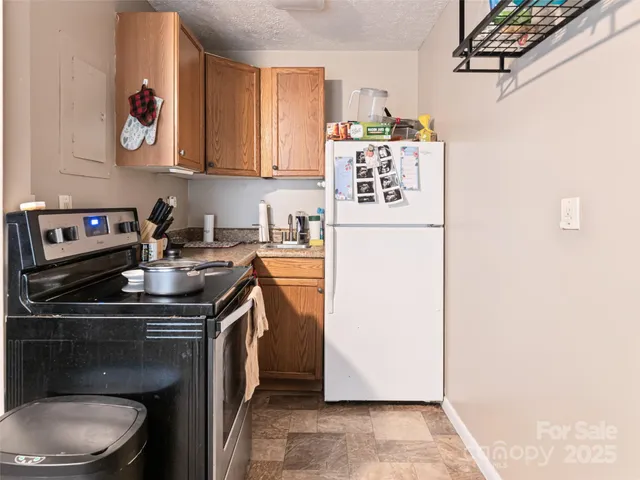 a kitchen with a sink a stove and cabinets