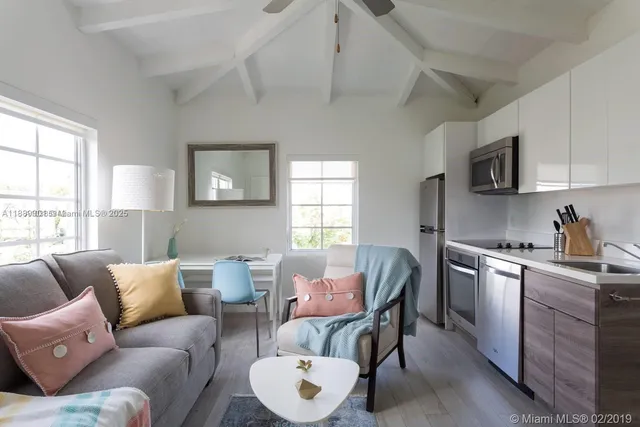 a living room with furniture a dining table and chairs