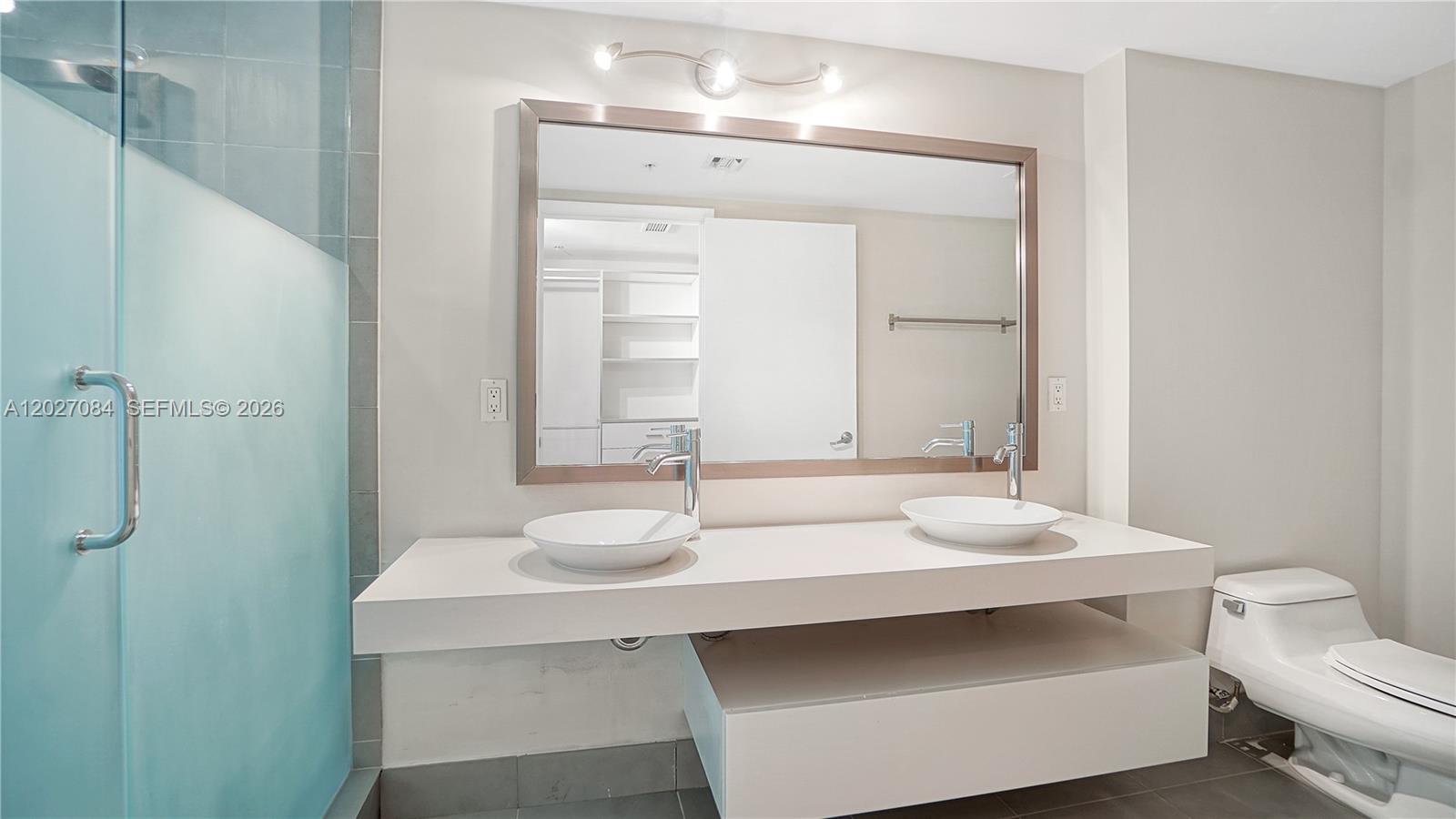 92 Southwest 3rd Street, Unit 1803 Miami, FL 33130 - Photo 9 of 29 a bathroom with a sink and a mirror
