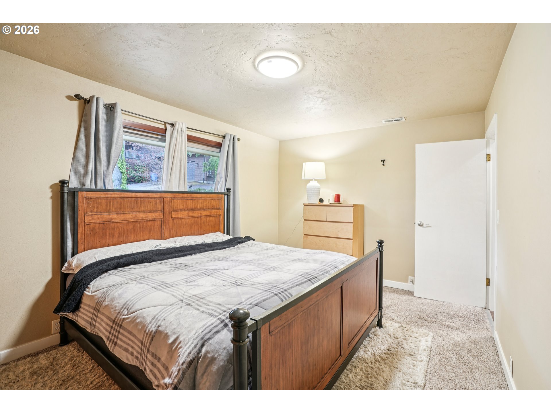 12444 Southwest 57th Avenue Portland, OR 97219 - Photo 12 of 44 a bedroom with a bed and a dresser