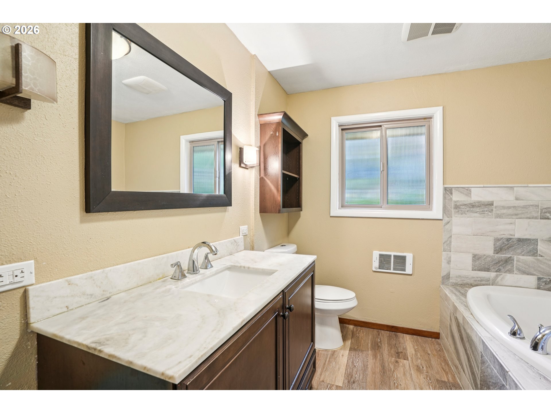 12444 Southwest 57th Avenue Portland, OR 97219 - Photo 13 of 44 a bathroom with a sink a toilet a vanity and mirror
