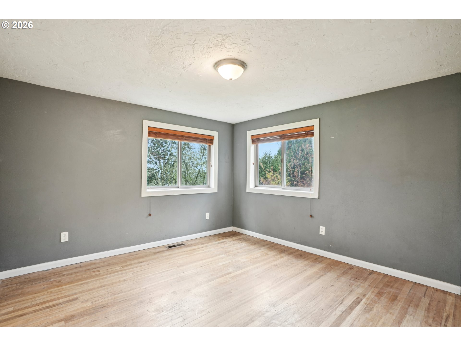 12444 Southwest 57th Avenue Portland, OR 97219 - Photo 24 of 44 wooden floor in an empty room with a window