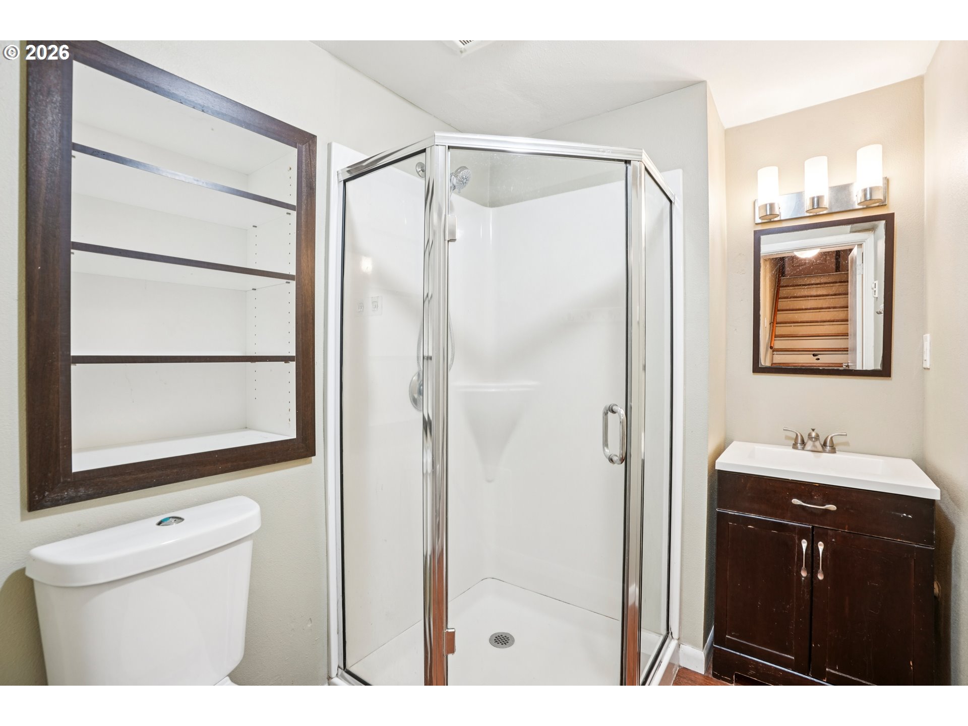 12444 Southwest 57th Avenue Portland, OR 97219 - Photo 25 of 44 a bathroom with a sink a mirror and a shower