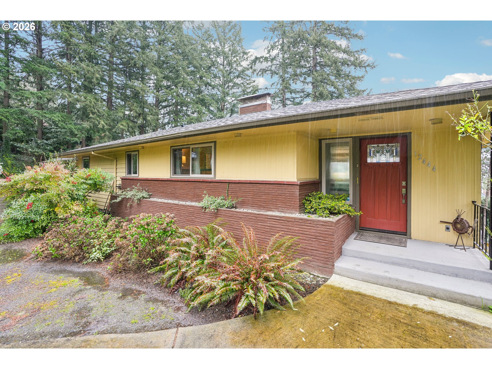 12444 Southwest 57th Avenue Portland, OR 97219 - Photo 3 of 44 a front view of a house with garden