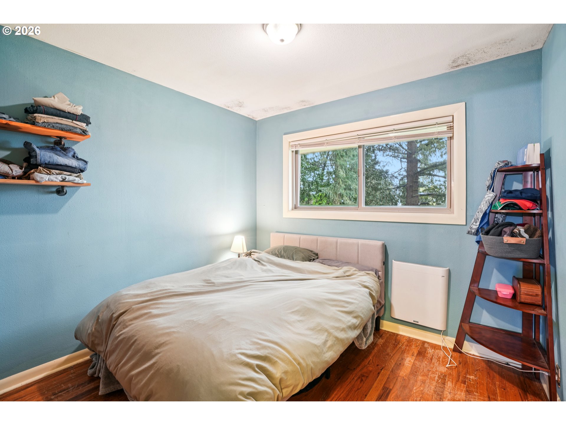 12444 Southwest 57th Avenue Portland, OR 97219 - Photo 33 of 44 a bedroom with a bed and a window