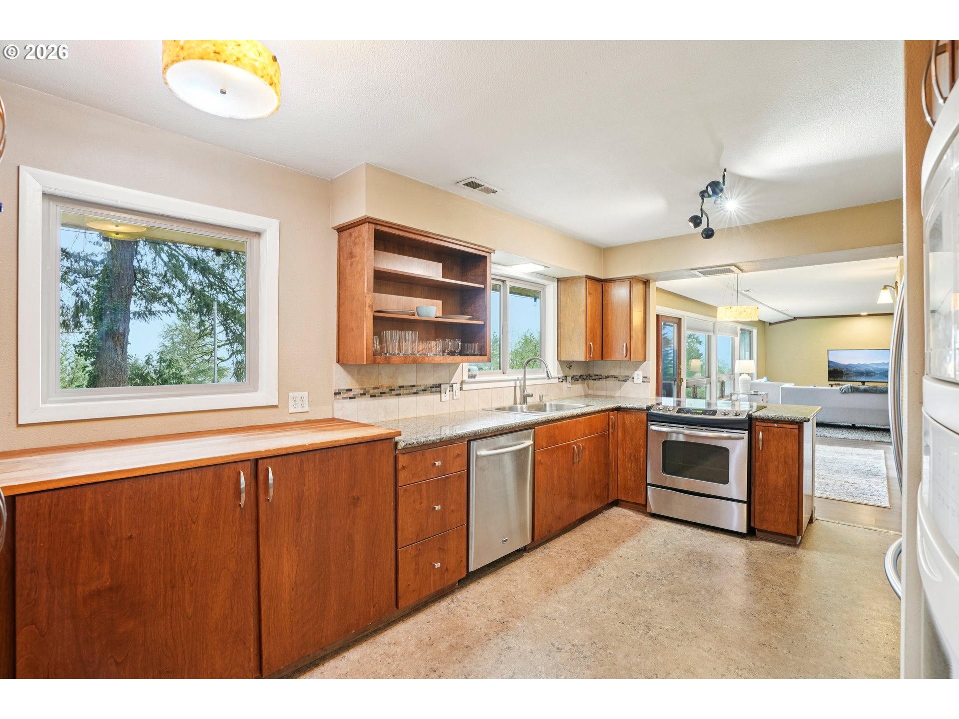 12444 Southwest 57th Avenue Portland, OR 97219 - Photo 10 of 44 a large white kitchen with a large window