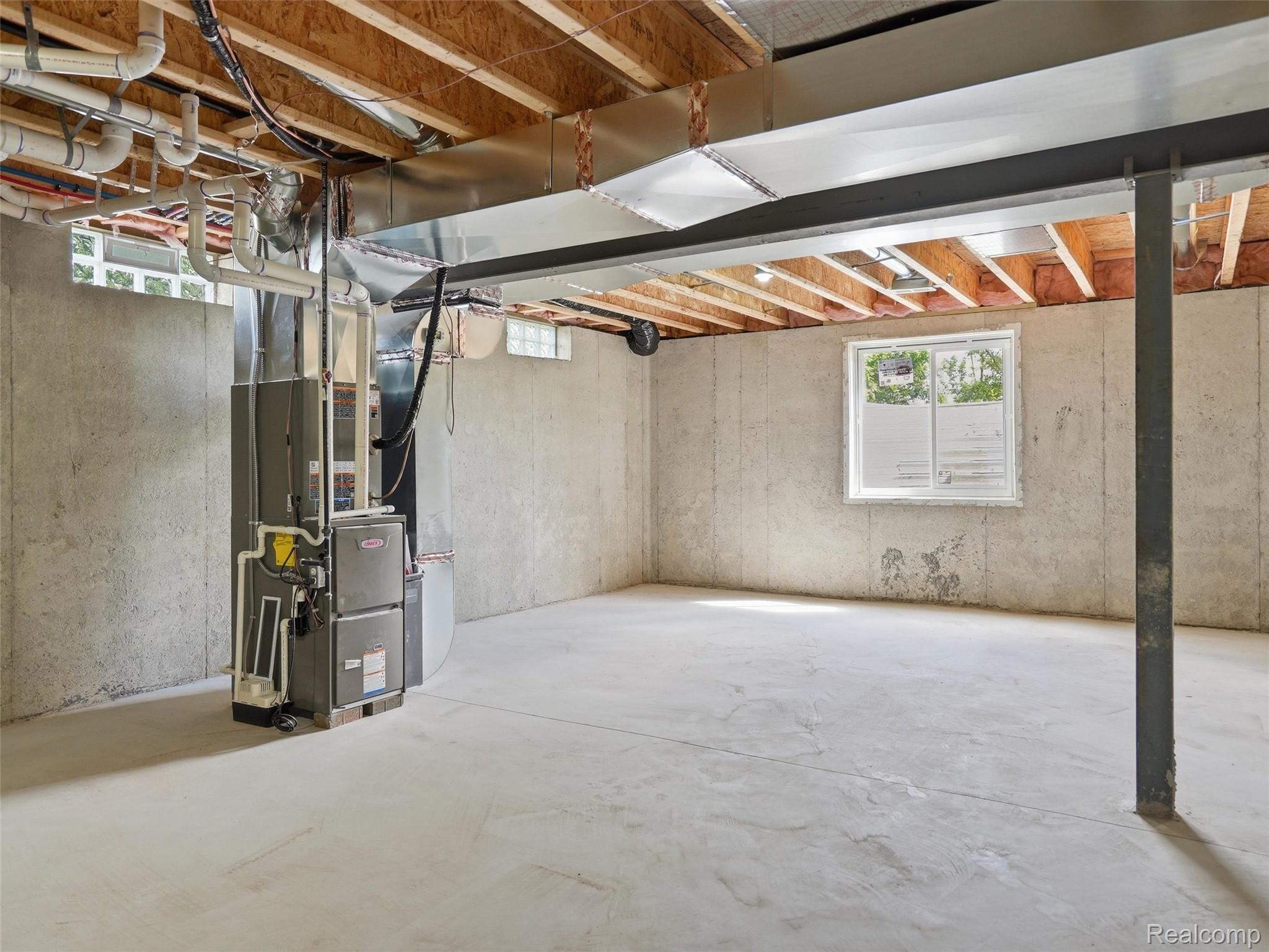 77850 Angling Road Richmond, MI 48062 - Photo 46 of 54 Unfinished basement with concrete slab flooring and exposed wood ceiling joists