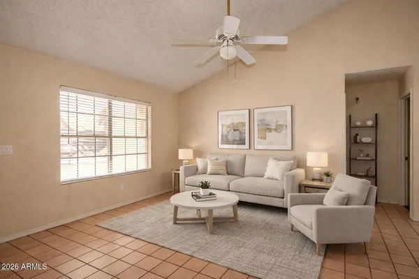 a living room with furniture a table and a window