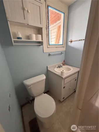 a bathroom with a toilet sink and mirror