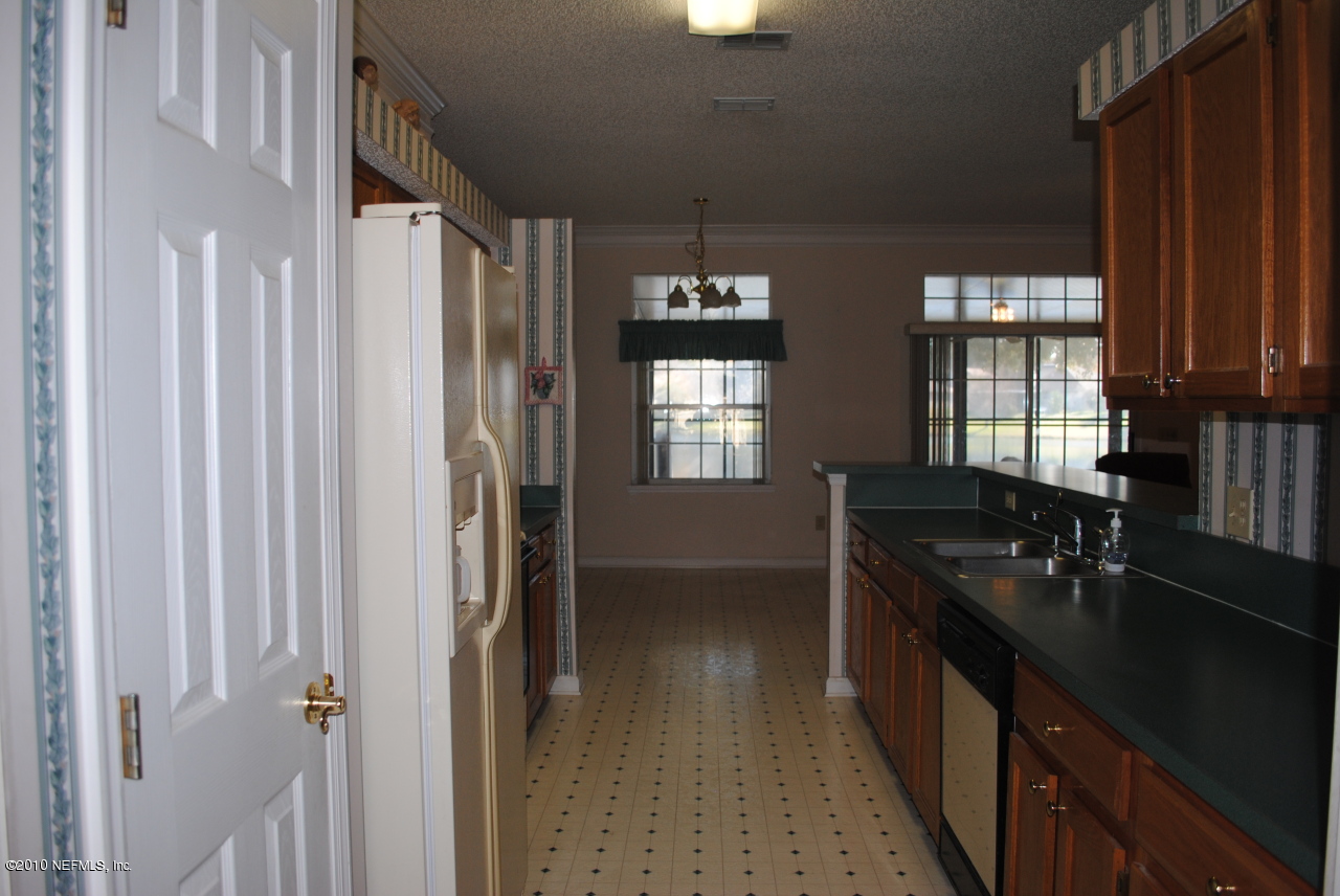 11883 Swooping Willow Road Jacksonville, FL 32223 - Photo 4 of 20 Galley kitchen with large breakfast bar