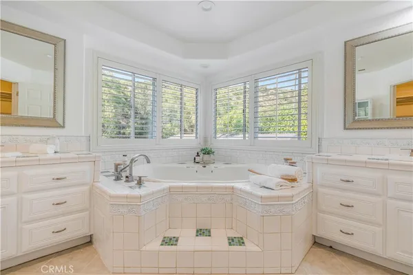 a spacious bathroom with a granite countertop sink and a mirror
