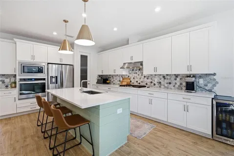 a view of a dining room with furniture wooden floor and a chandelier