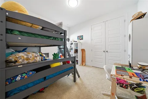 an aerial view of a house with a garden and lake view