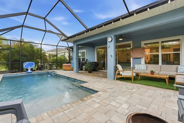 a view of a swimming pool with outdoor seating