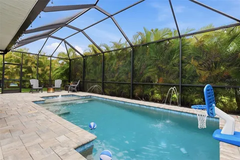a view of swimming pool with a table and chairs