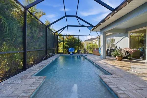 a living room with furniture kitchen view and a flat screen tv