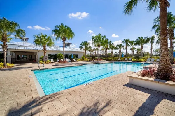 an aerial view of a house with swimming pool and outdoor seating