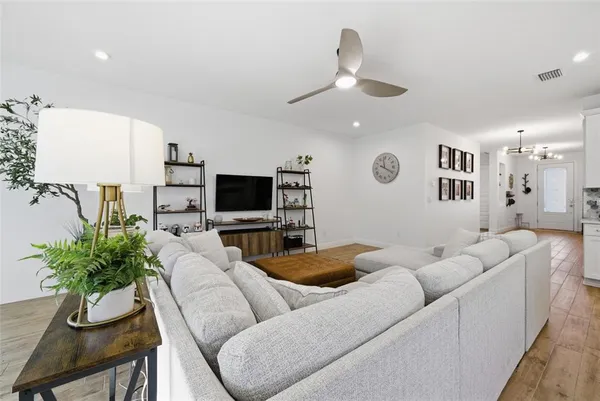 a living room with furniture a rug and a large window
