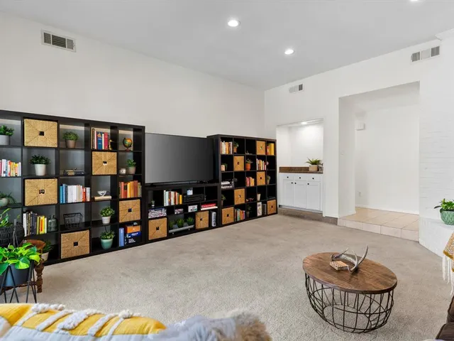 a living room with lots of furniture and a book shelf