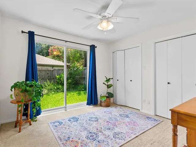 a very nice looking room with a large window and flower pot
