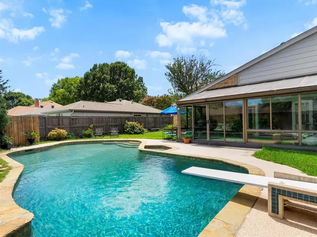 a view of a house with backyard sitting area and garden