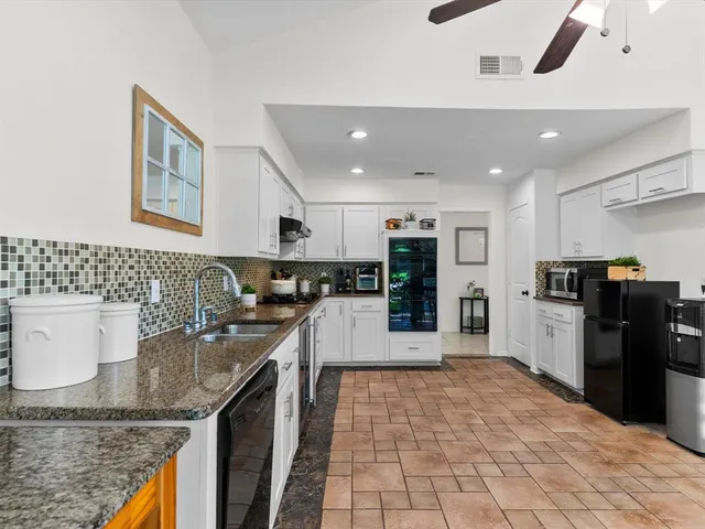 a kitchen with stainless steel appliances granite countertop a sink and stove