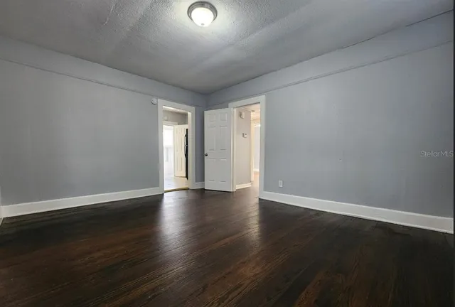 a view of an empty room and wooden floor