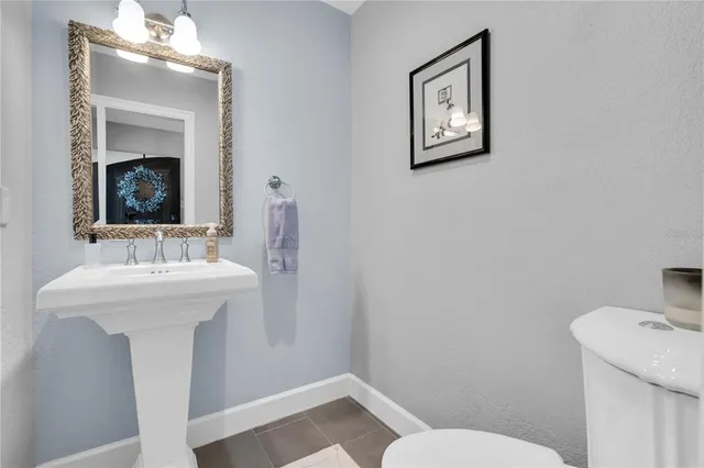 a bathroom with a sink mirror and toilet