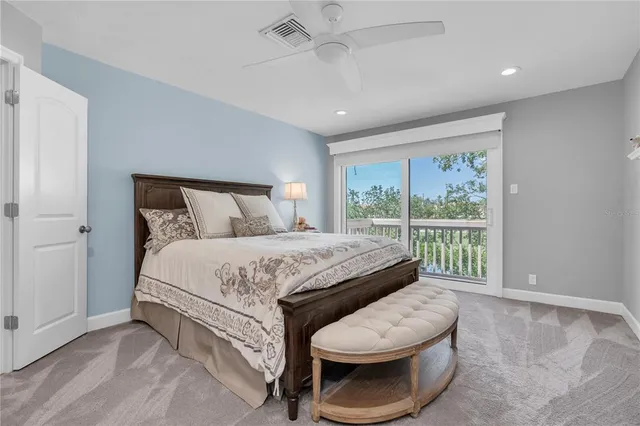 a bedroom with a large bed and a window