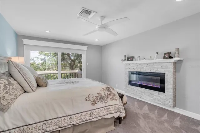 a bedroom with a large bed and a fireplace