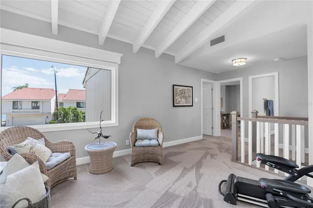 a living room with furniture a window and a flat screen tv